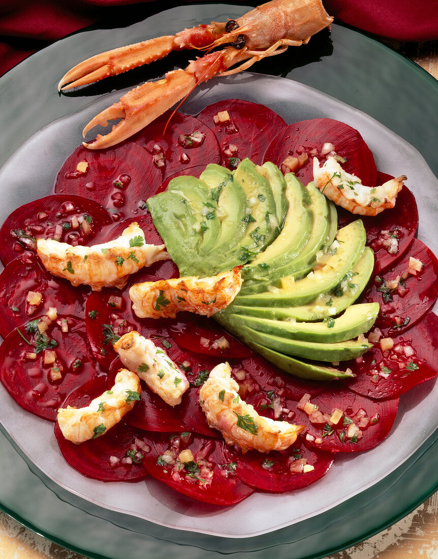 Winter salad with langoustines, beetroot, avocado and ginger on plate