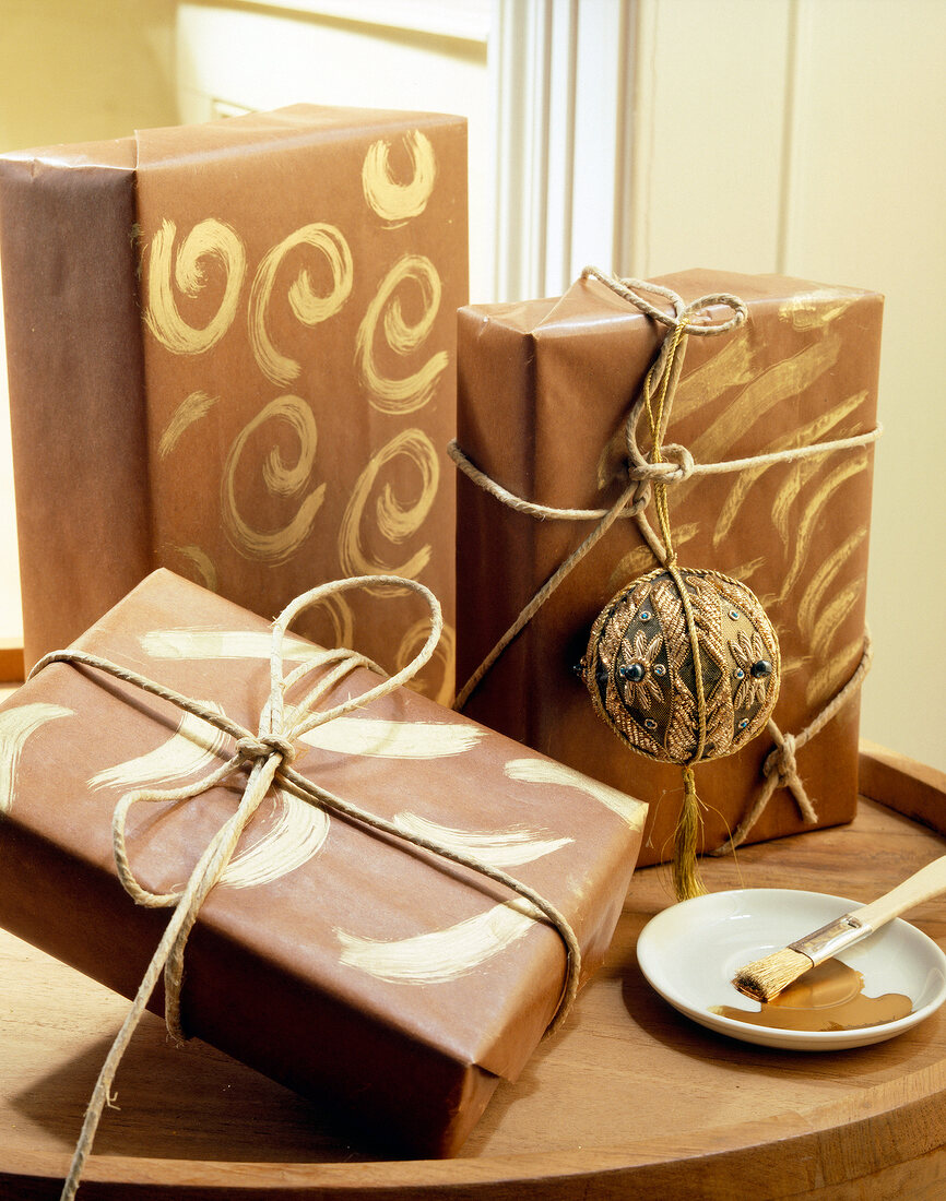 Three gifts wrapped in brown