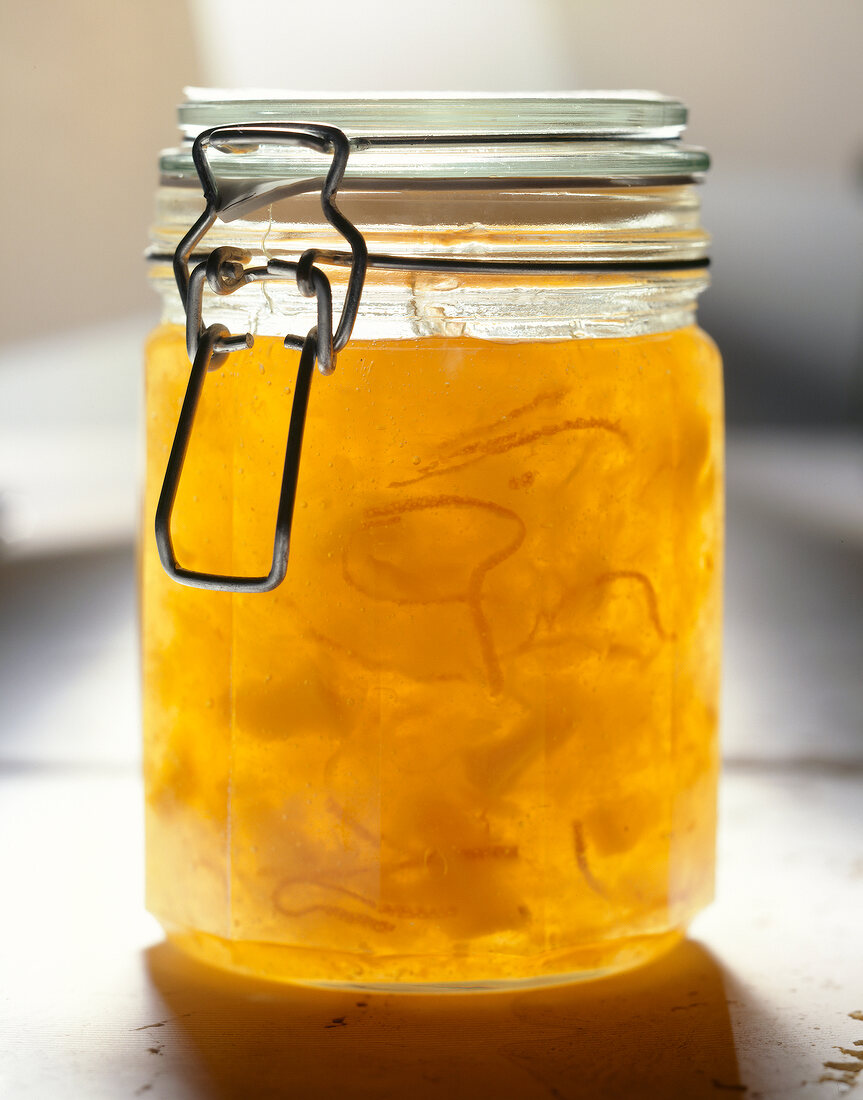 Close-up of yellow jam in glass jar