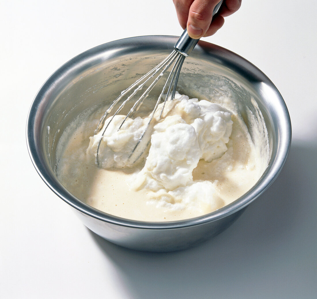 Whisking mixture of beer, flour and egg in bowl