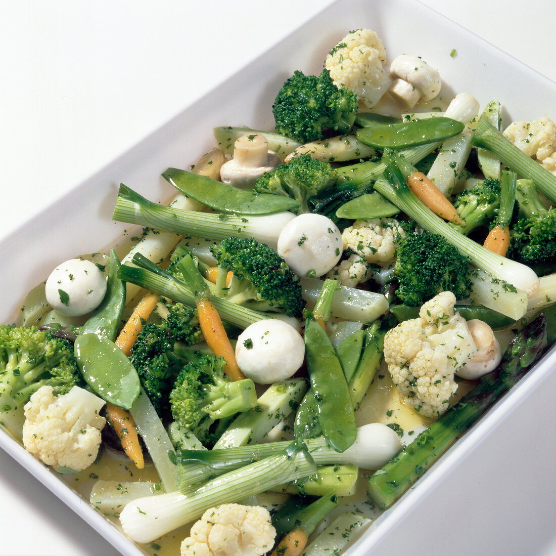 Chopped broccoli, carrots and other vegetables in serving dish