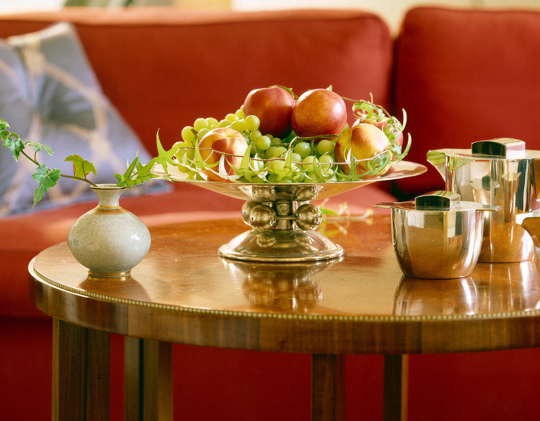 Bowl of grapes and apples on table