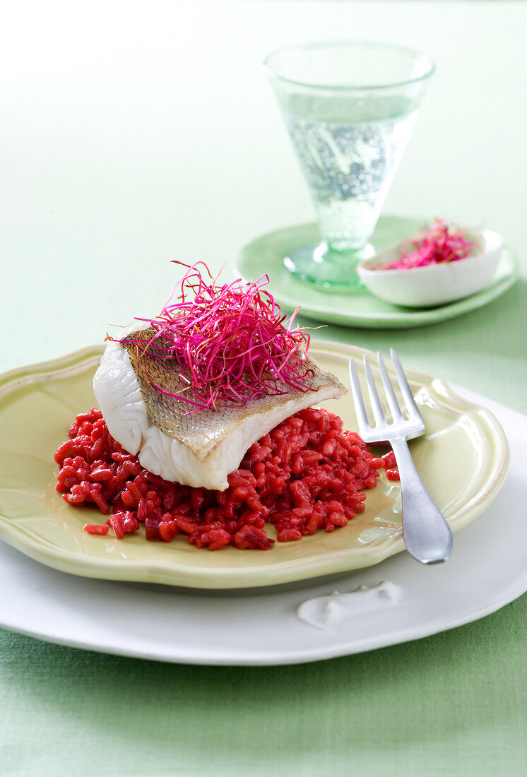 Zander fillet with beetroot risotto on plate