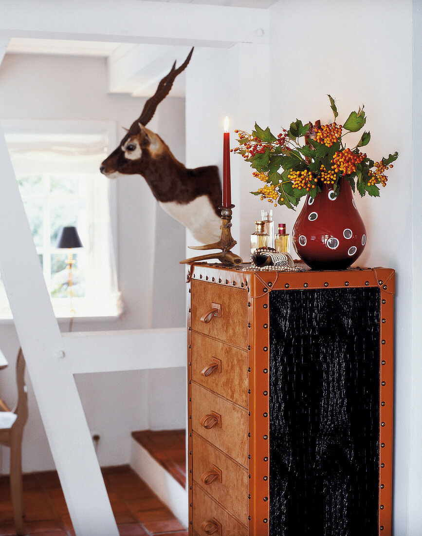 Lilt candles, perfume, and flower vase on wardrobe chest with drawers