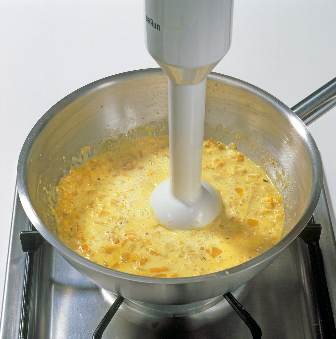 Pumpkin mixture being pureed with hand blender, step 5