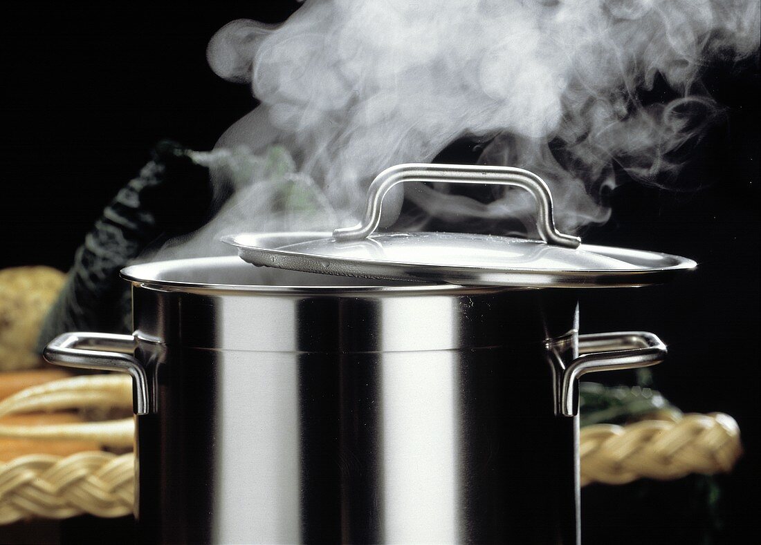 Metal pot with open lid and hot food with steam coming from it. Dark  background. The chef. Generative AI 22771509 Stock Photo at Vecteezy