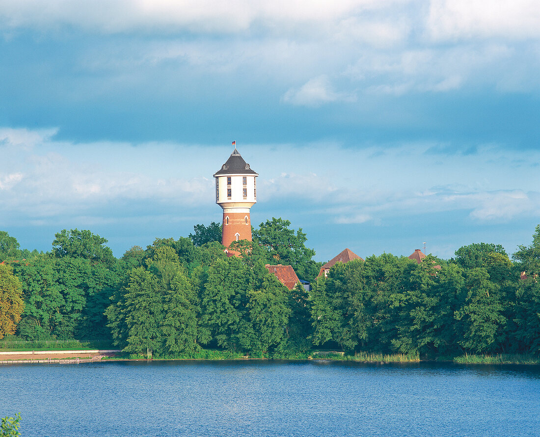 View of Glambecker lake, water tower and trees, Neustrelitz, Germany