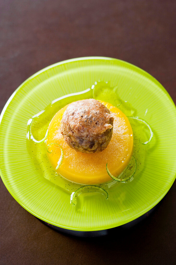 Baked chocolate croquettes with frozen passion fruit and whiskey on plate