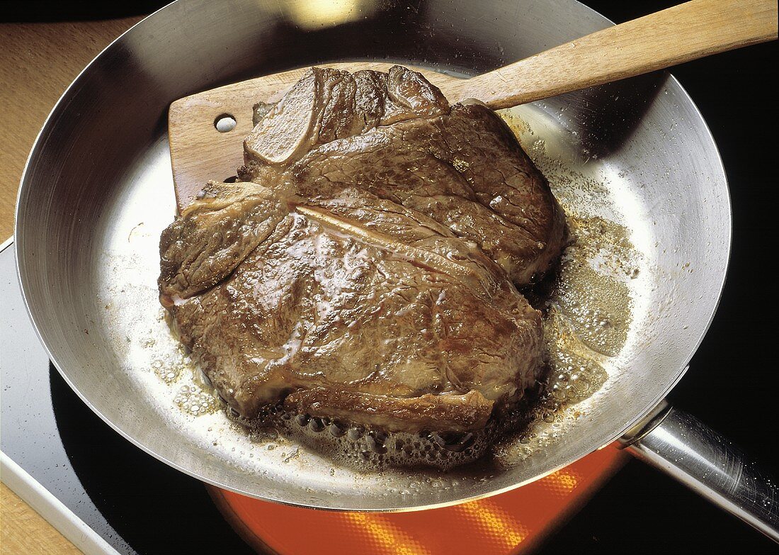 Porterhouse Steak Frying in a Skillet