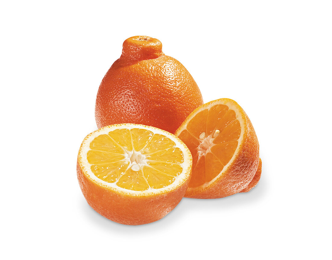 Whole and halved tangelo orange on white background
