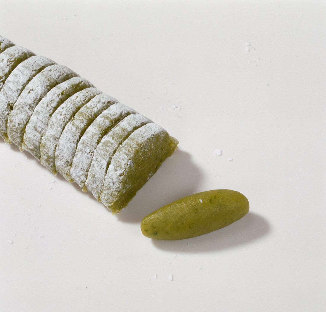 Sliced marzipan pistachio on white background, step 3