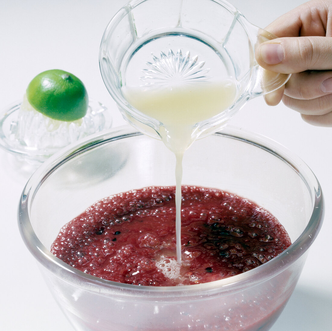 Lime juice being poured in tamarillo fruit puree