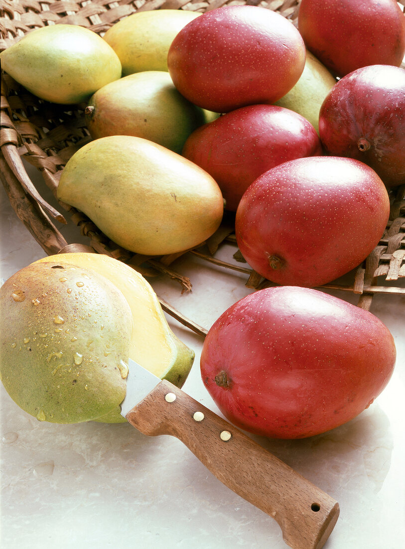 Red and green mangoes in basket