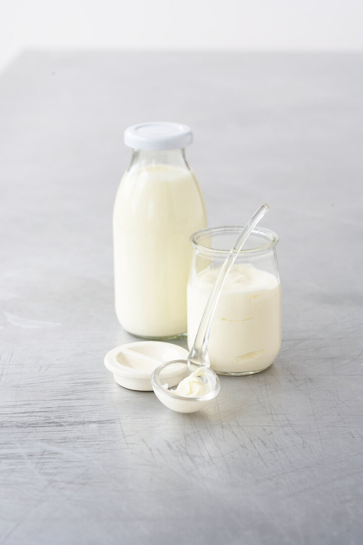 Milk and cream in bottle with spoon