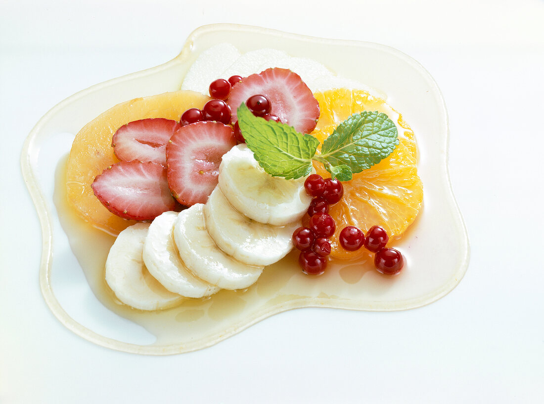 Fruit with granadilla sauce on white background