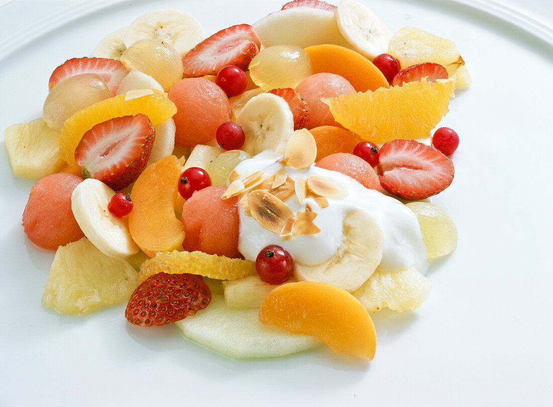 Fruit salad with yogurt sauce on plate