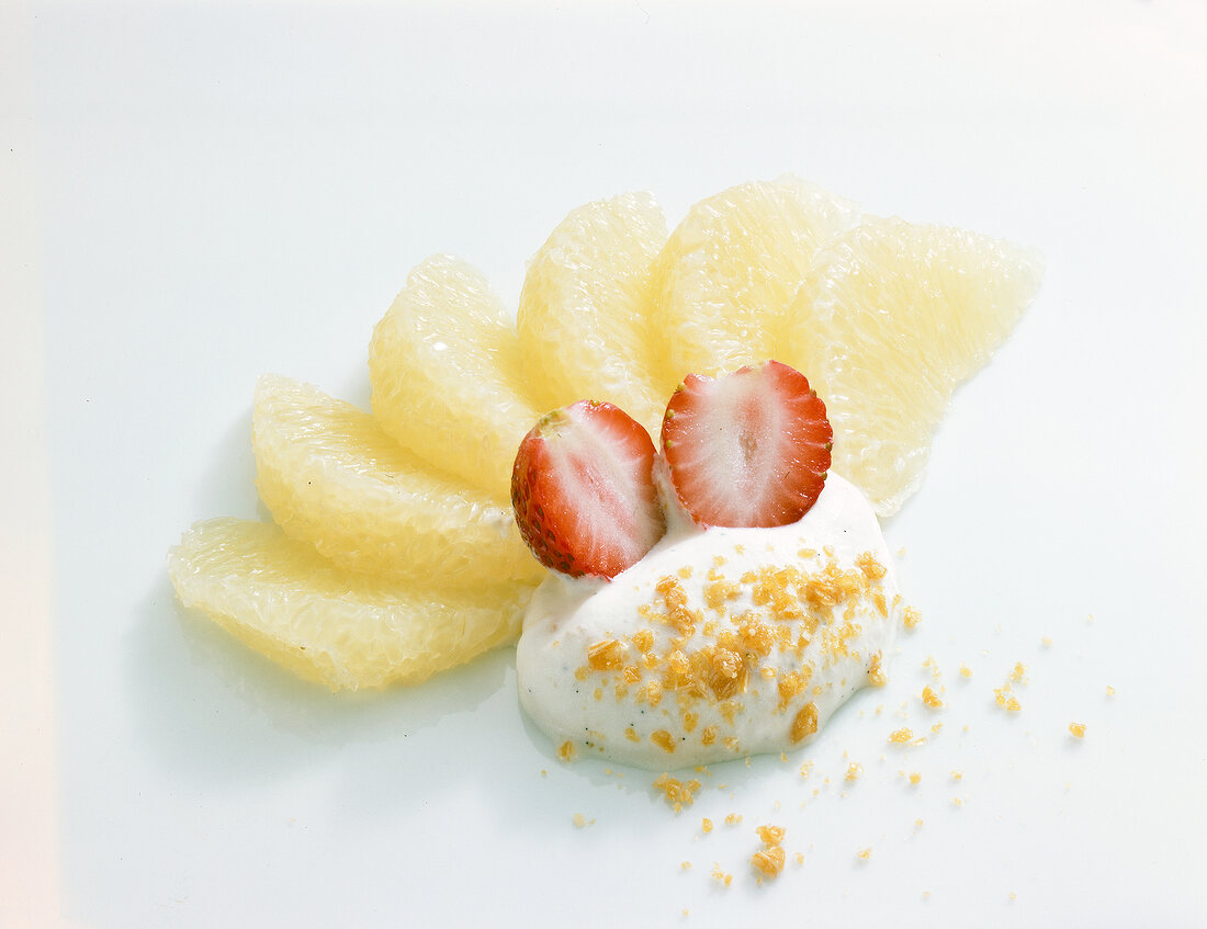 Grapefruit dessert with strawberries on white background