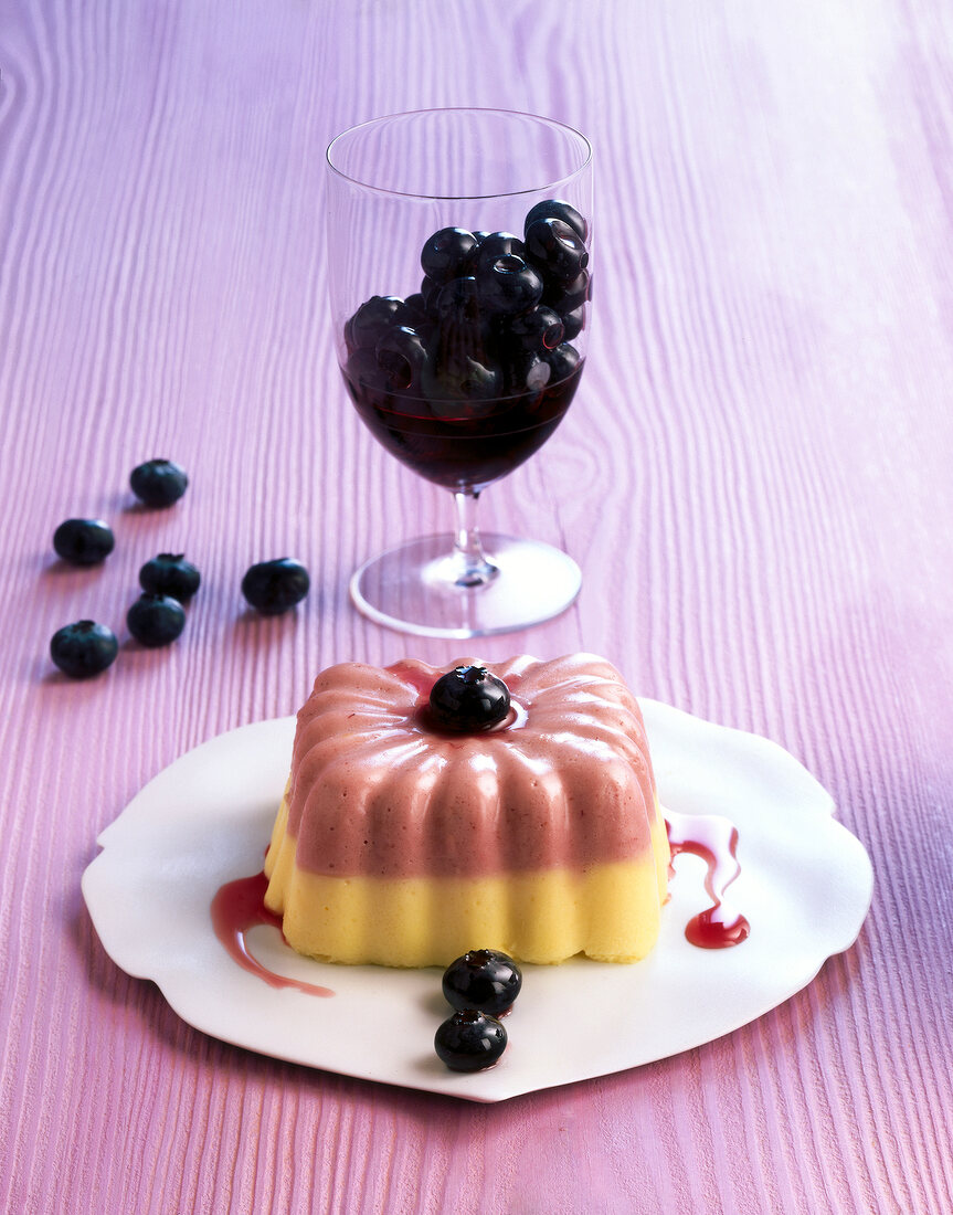 Blueberry buttermilk timbale on plate and blueberries in glass