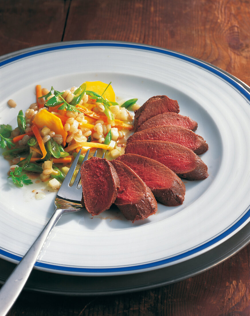 Hare with vegetable salad on plate