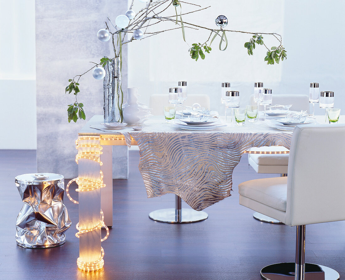 Festively decorated table in white-silver accents with zebra pattern table cloth