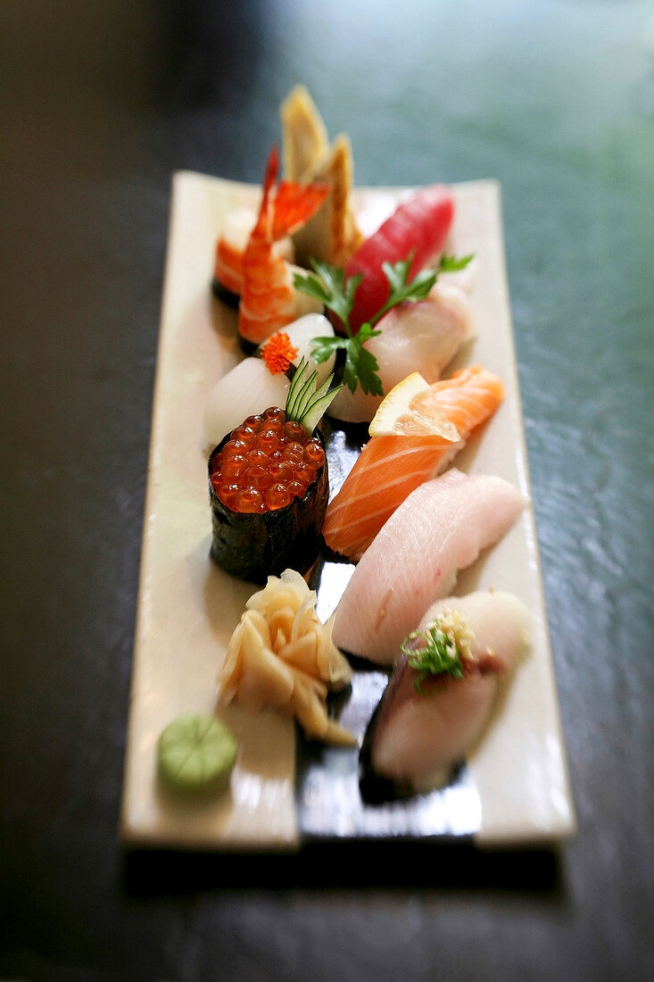 Various sushi on wooden board