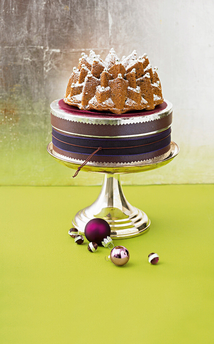 Baileys cake decorated with beads on silver cake stand