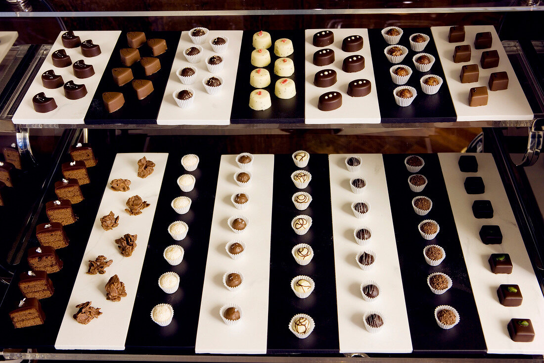 Different types of chocolates on black-white tray