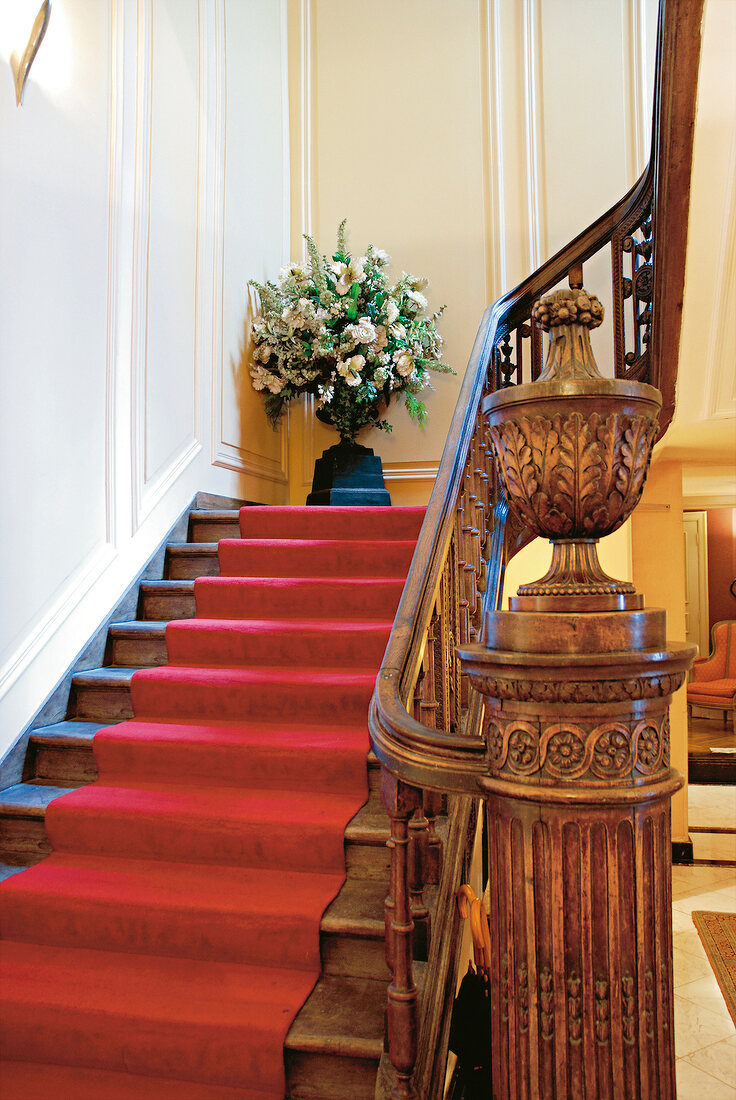 Staircase with red carpet and wooden railings at Hotel Dixseptieme in Brussels, Belgium