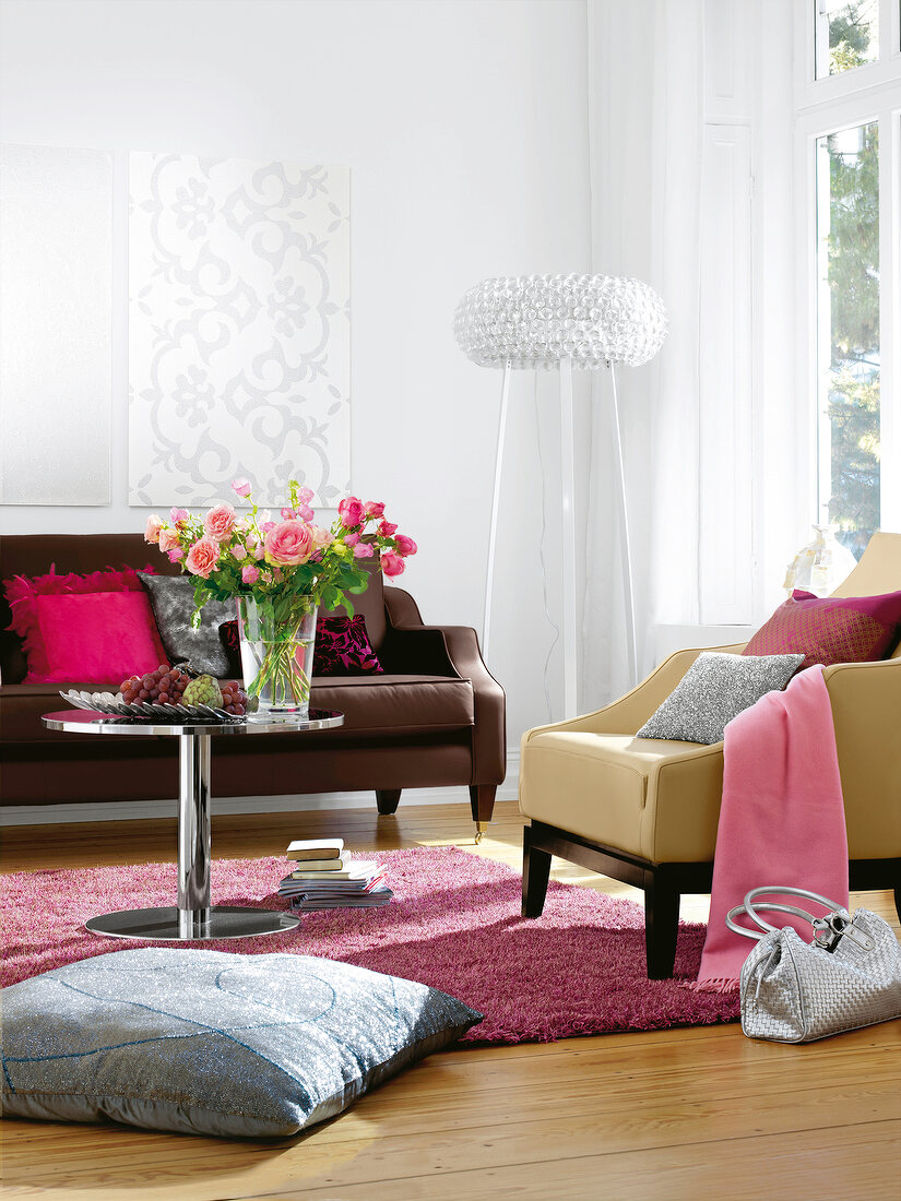 Living room with white walls, brown and beige leather sofa and pink carpet