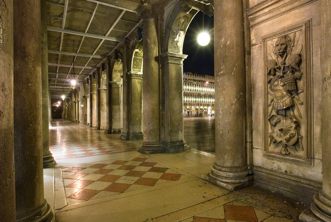 View of arches and columns of St. Mark's Square at night