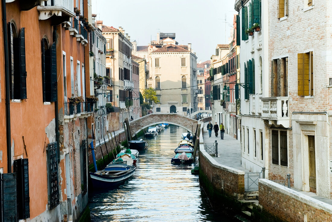 View of buildings, foot bridge and narrow canal in Venice, Italy