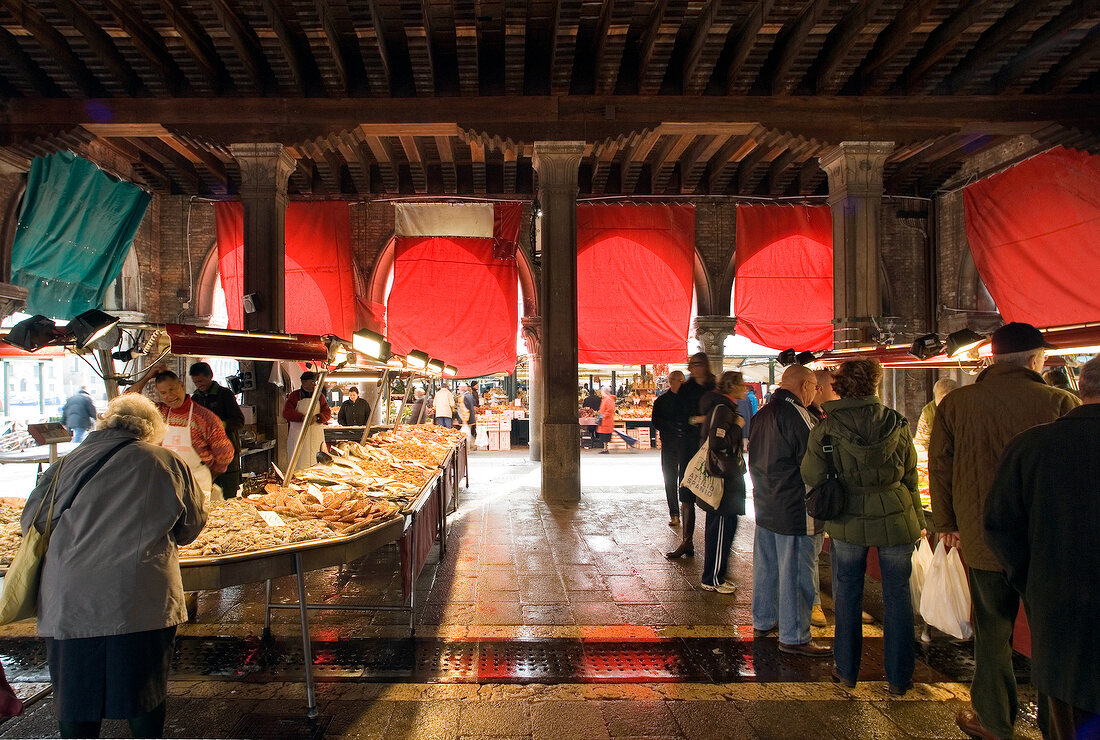 View of people shopping at market stalls at Rialto bridge, Venice, Italy