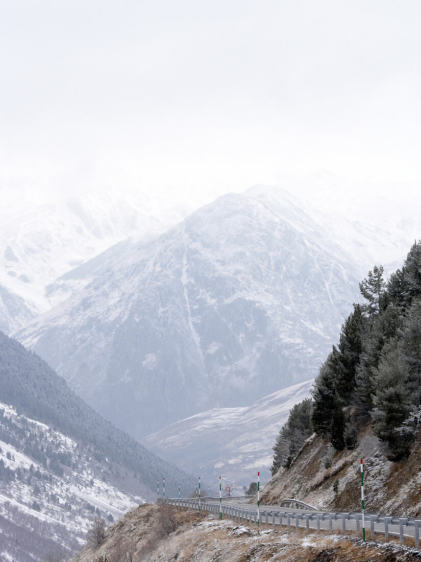 Road passing through valley in Pyrenees mountains, Spain