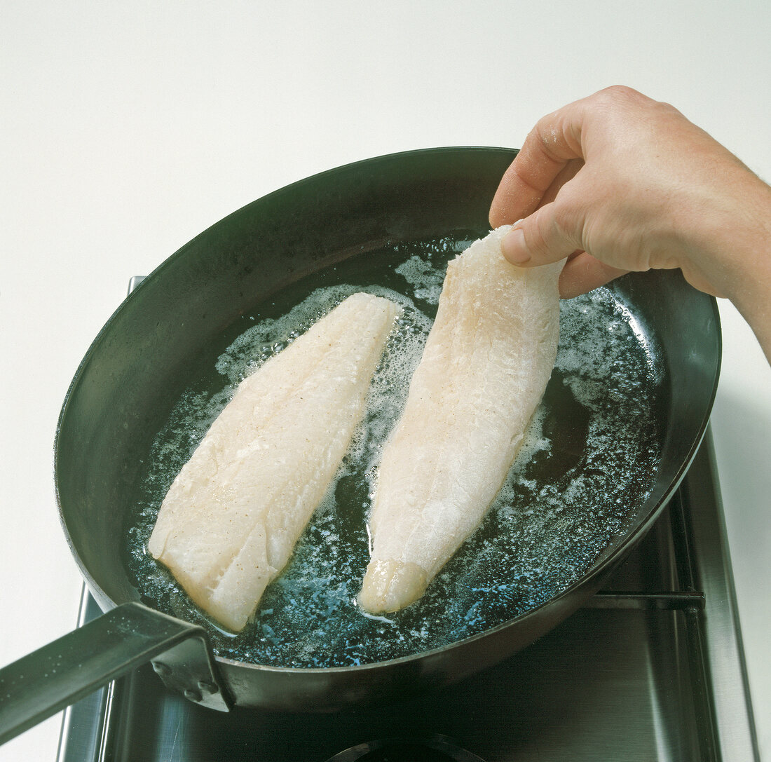 Merlan fillets being cooked in pan, step 2