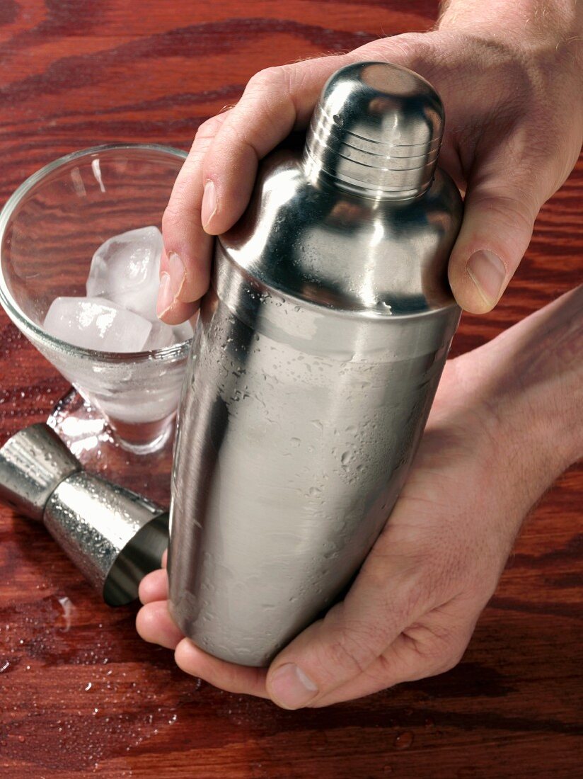 Hands holding cocktail shaker