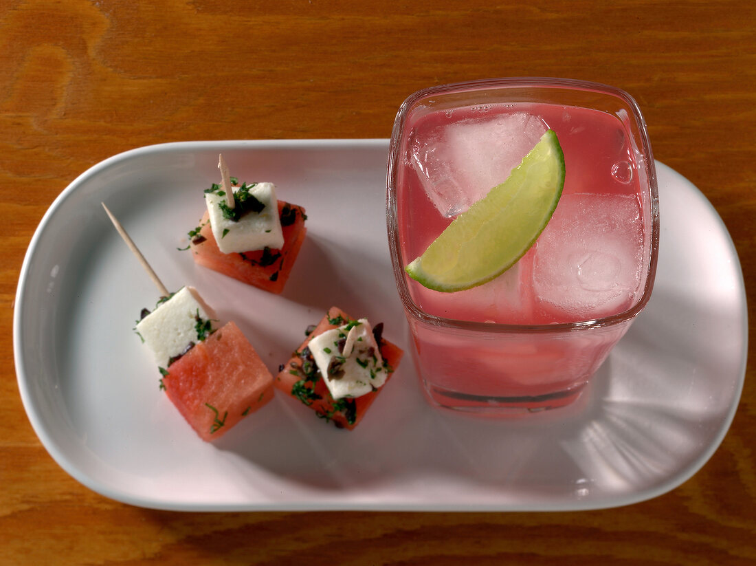 Sea breeze drink in glass with melon feta cubes