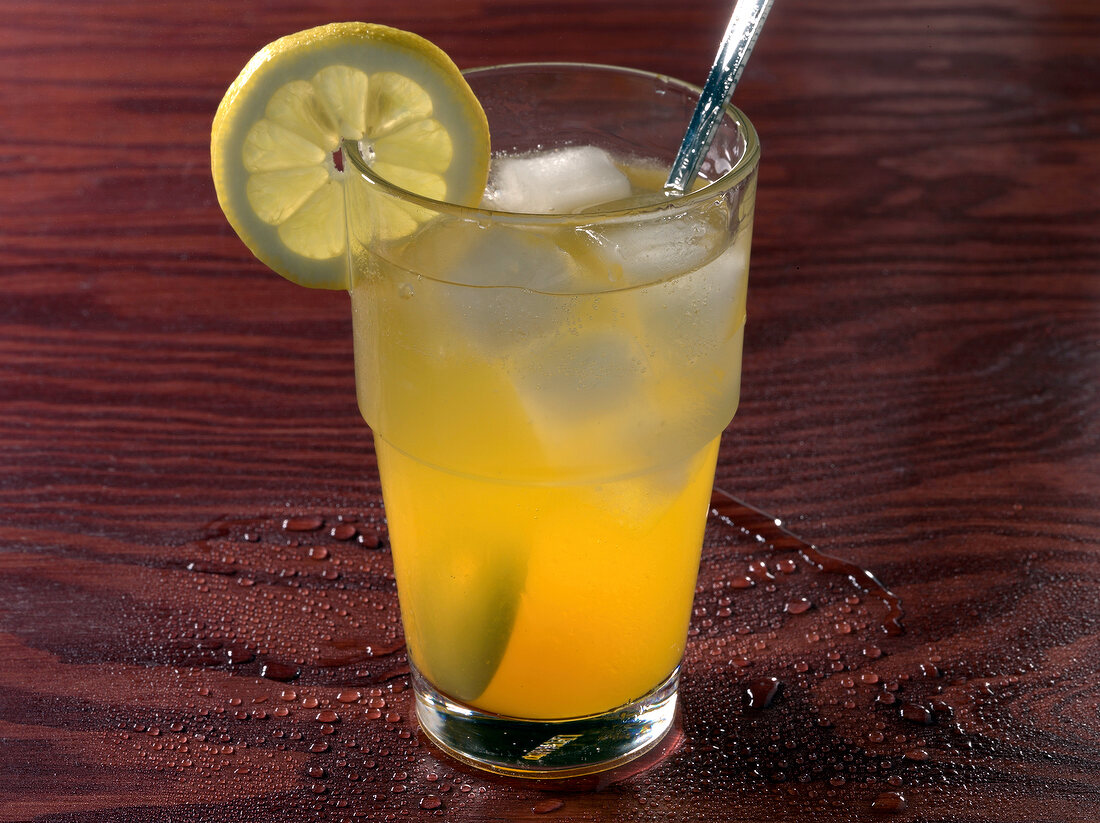 Tropical wine cooler drink with lemon slice on rim
