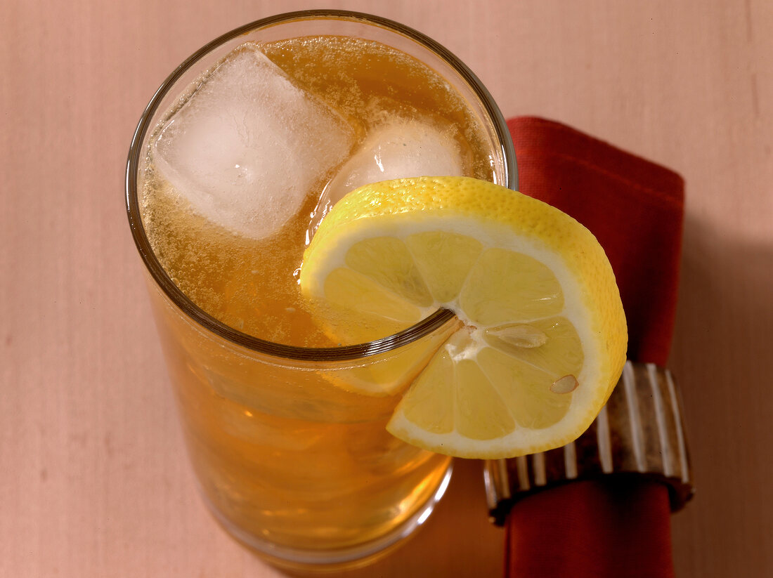 Fish house punch drink with sliced lemon on rim