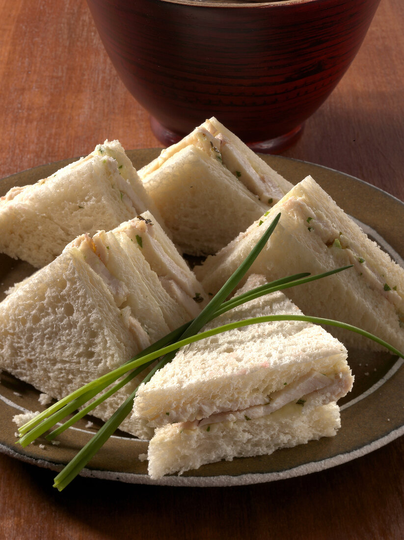 Close-up of chicken and herb sandwiches on plate