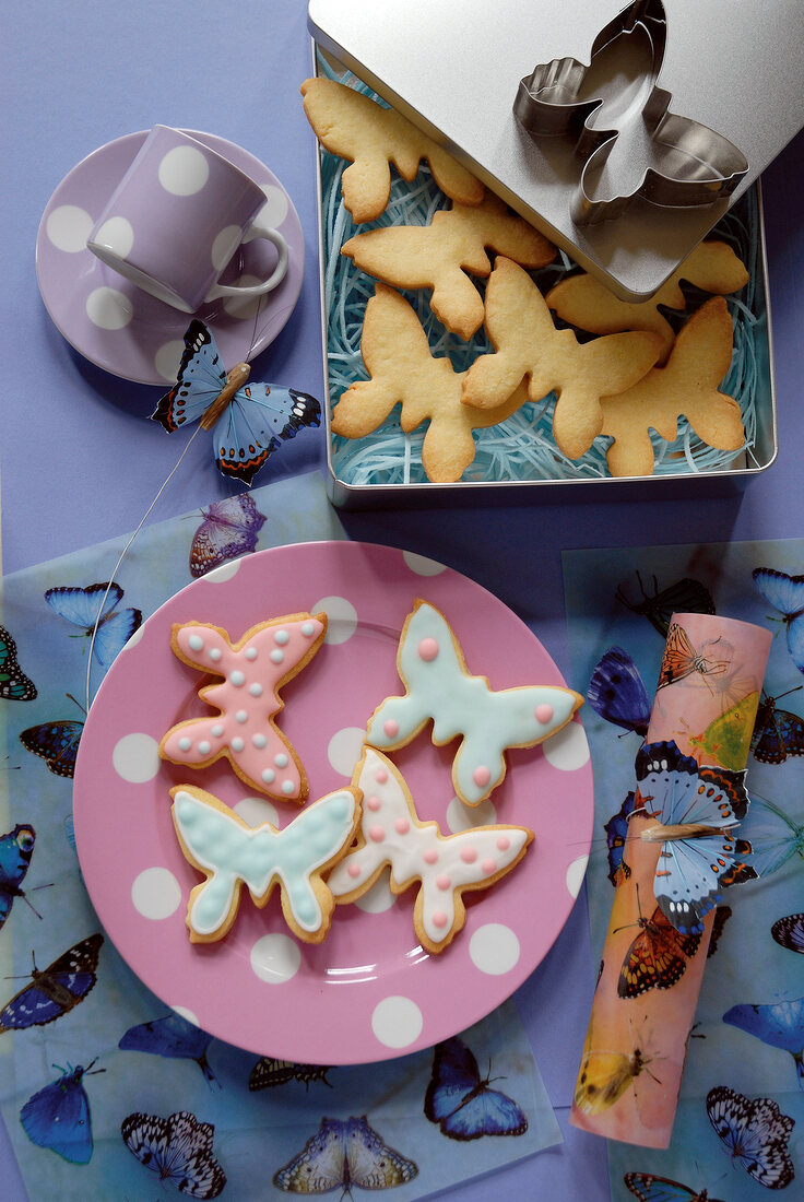 Butterfly shaped cookies on pink plates