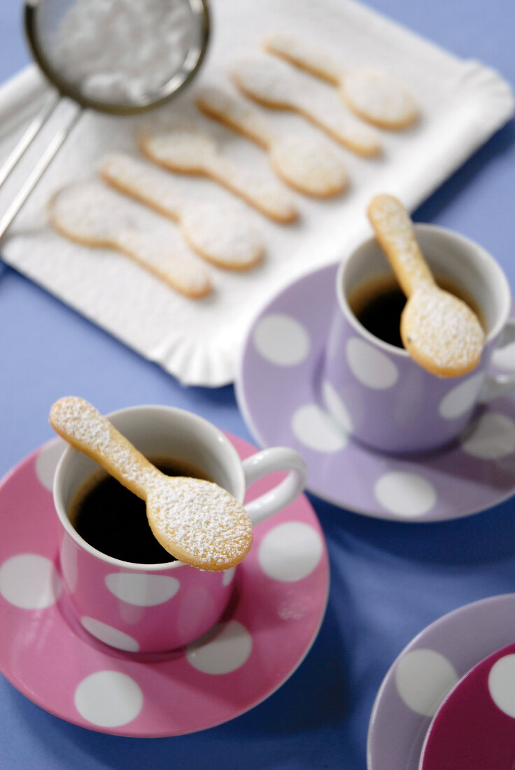 Spoon shaped cookies on cup of coffee
