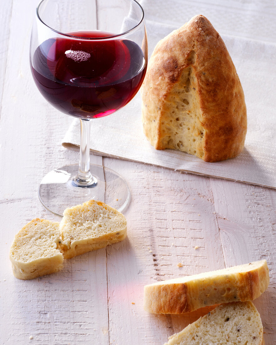 Pieces of potato bread and glass of red wine