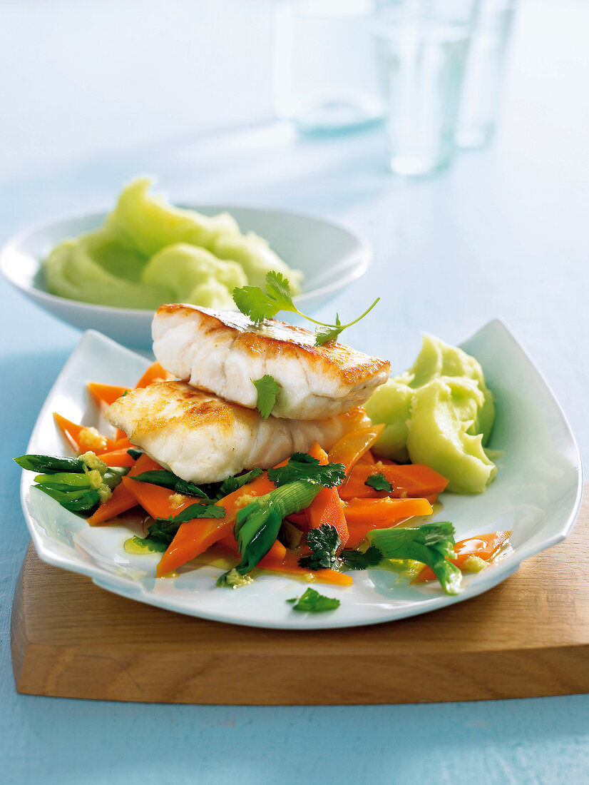 Ling fish fillet with coriander and carrot in serving dish