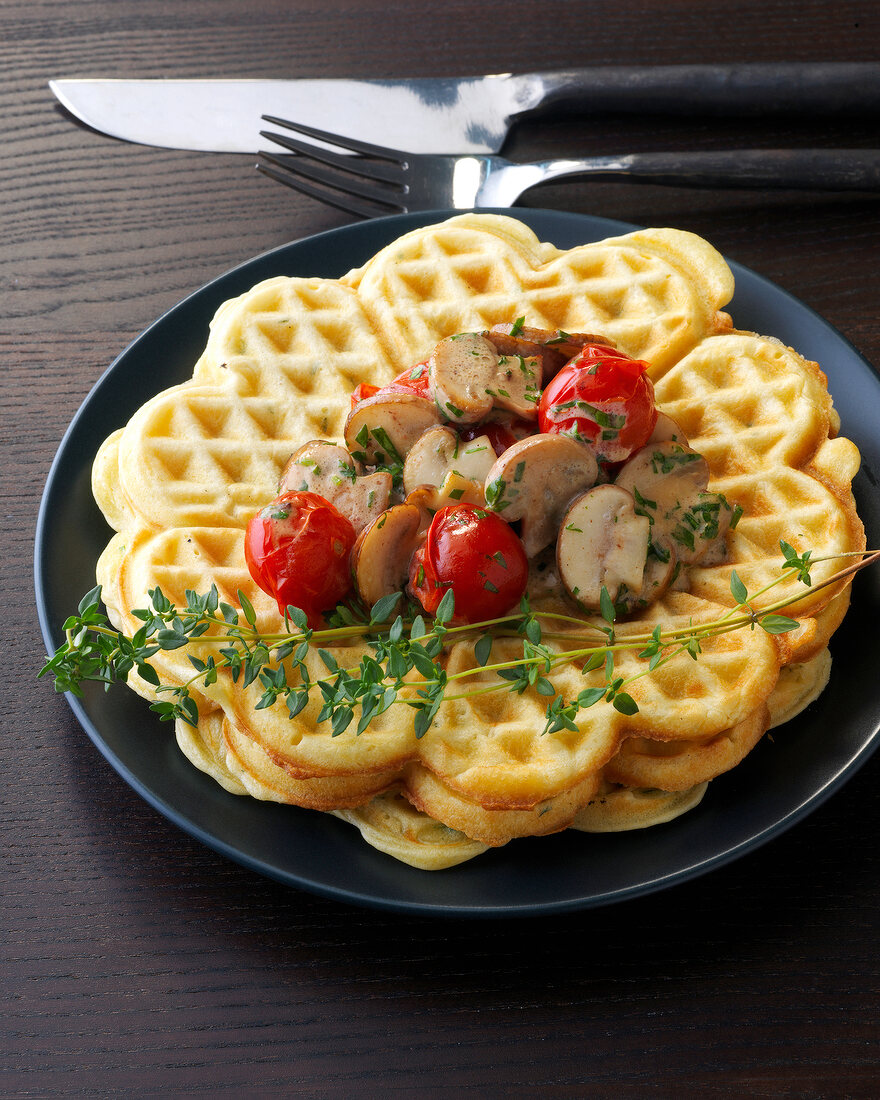 Waffles with mushroom and thyme sauce on plate