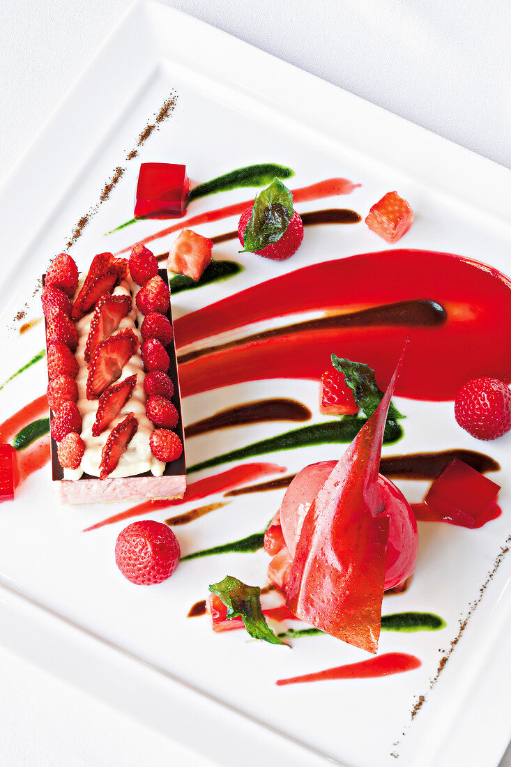Strawberry jelly, strawberry sorbet with olive puree and basil puree on tray