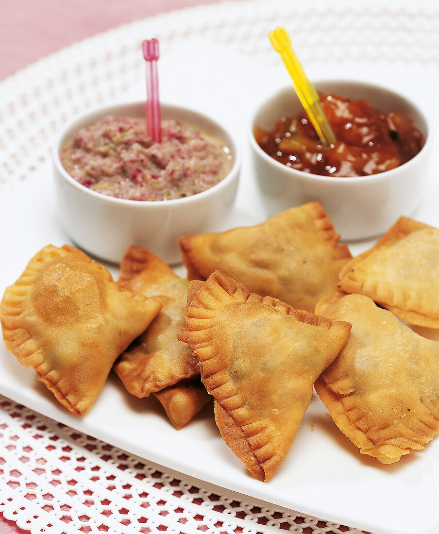 Close-up of dips with snacks