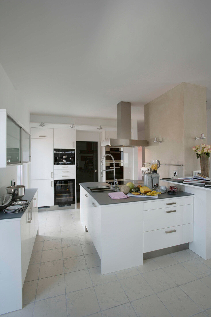 White walls, chimney and light gray countertops in kitchen