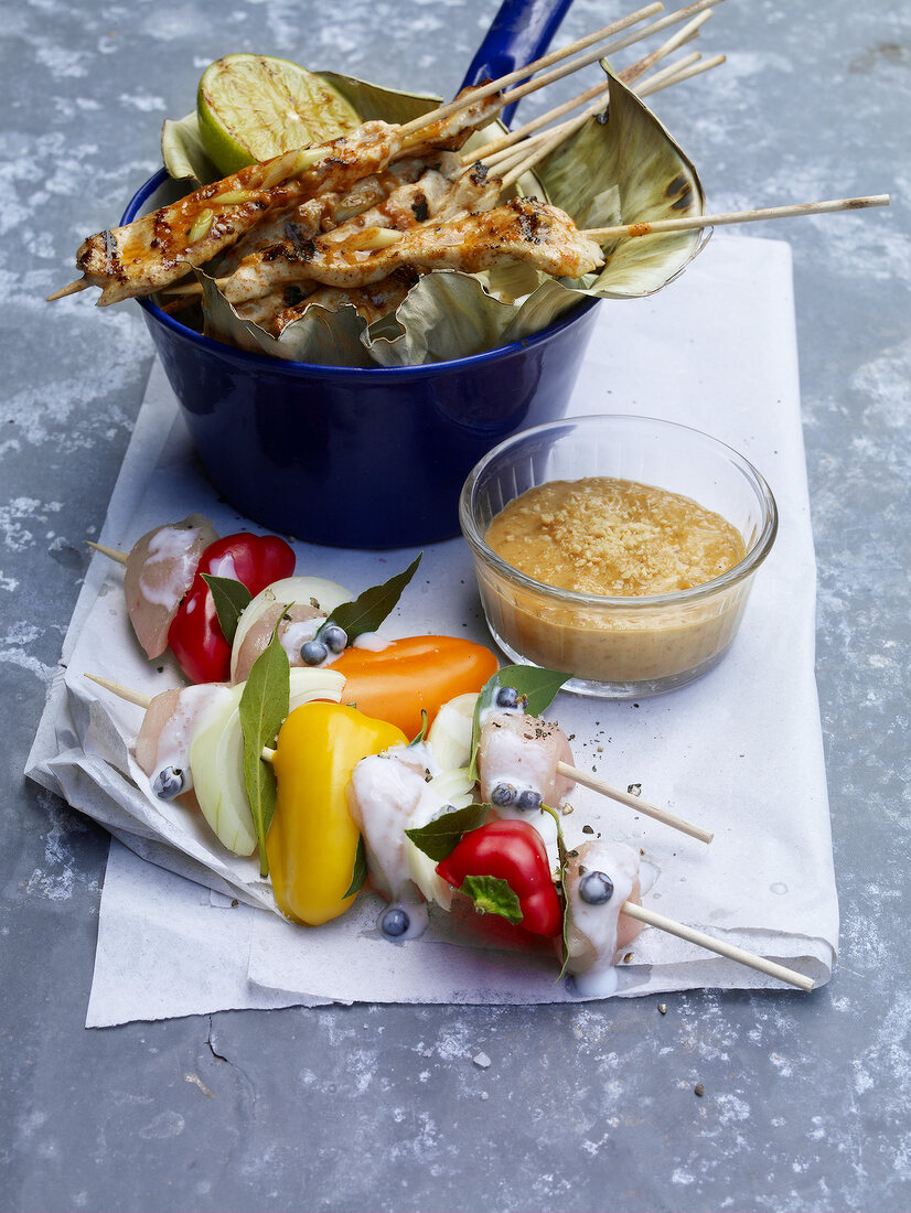 Rabbit shashlik in sauce pan, satay and peanut sauce in bowl