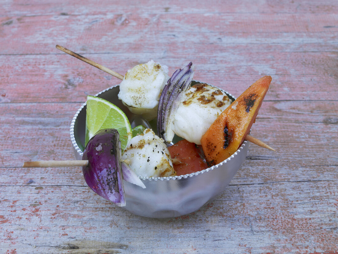 Monkfish and papaya skewer in bowl