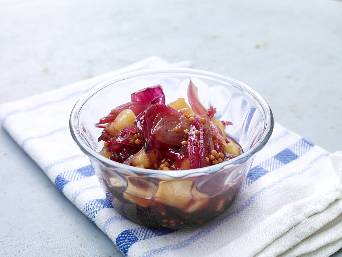 Bowl of onion and pineapple relish on folded napkin